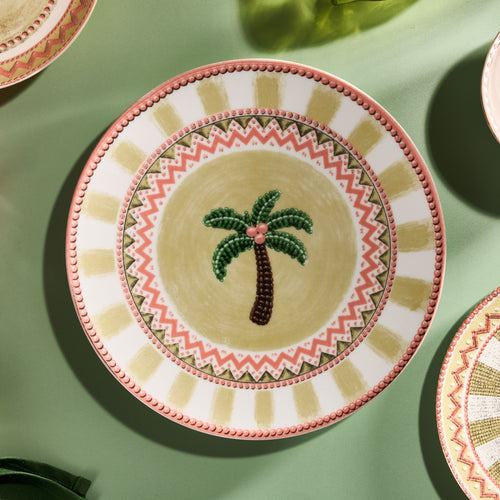 A Tale in Beads dinner plate with beaded palm tree motif, seen from above
