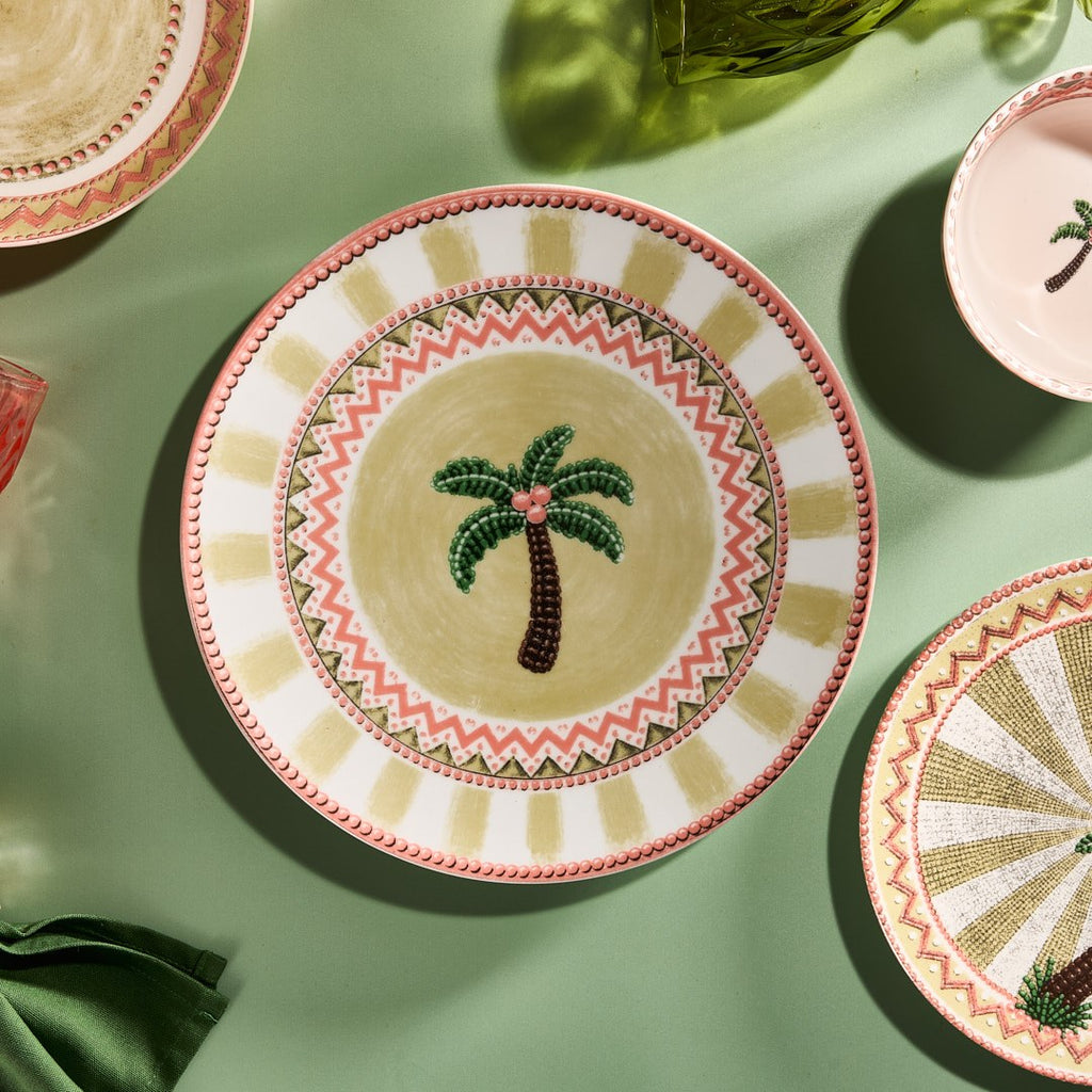 A Tale in Beads dinner plate and dessert plate arranged on sage green linen