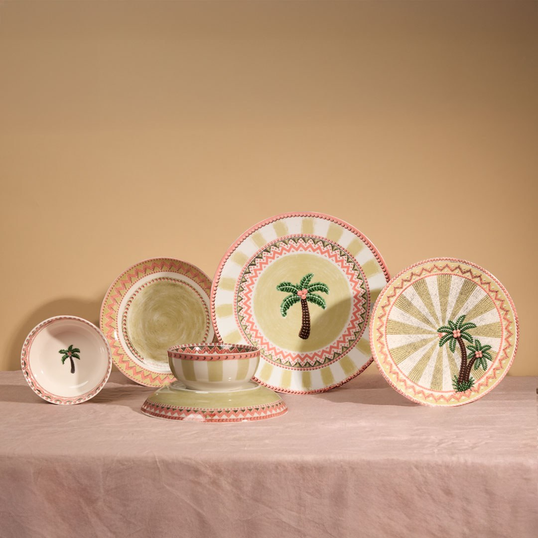 The full A Tale in Beads collection standing on pink linen