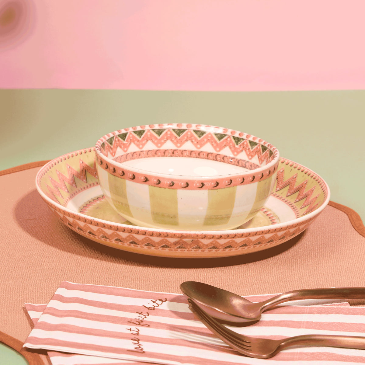 A Tale in Beads soup bowl resting in a salad plate with coral zigzag and beaded rim