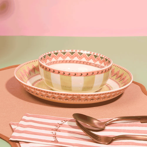 A Tale in Beads soup bowl resting in a salad plate with coral zigzag and beaded rim