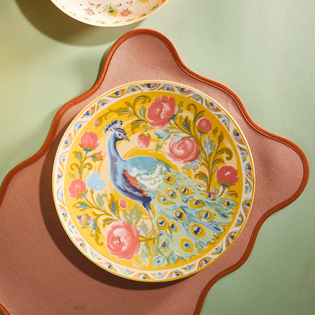 Pretty Past peacock dinner plate on a coral mat against sage green