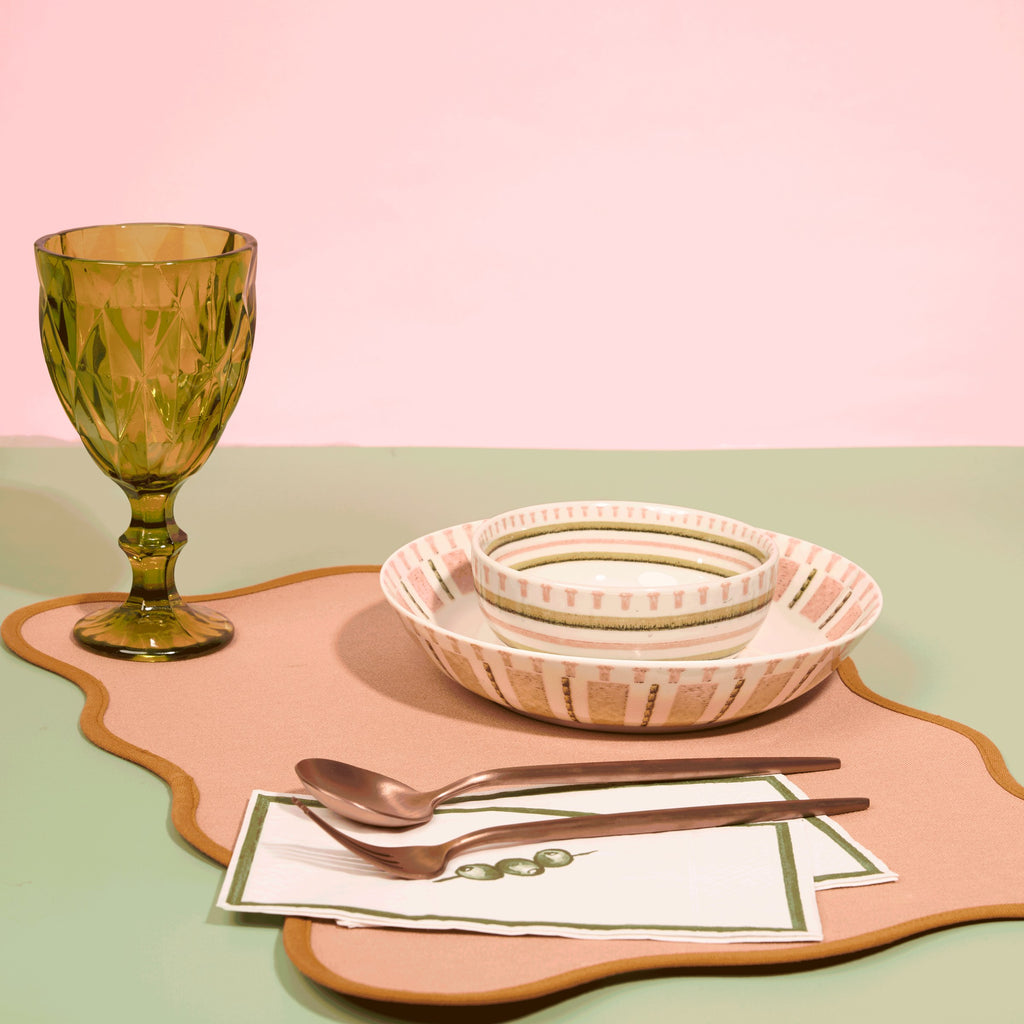 Stitches of the Wild place setting with striped salad plate, soup bowl and green glass